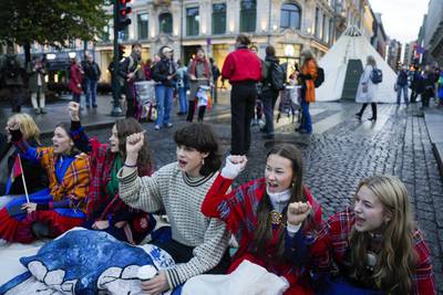 Activists, some wearing traditional Sami costumes, protest along Karl Johans gate street, in Oslo. AP