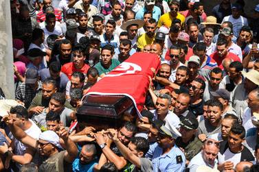 Mourners carry the coffin of killed Tunisian police officer Sgt. Arbi Guizani during a funerary procession in capital Tunis' northwestern suburb of Ettadhamen on July 9, 2018. AFP 