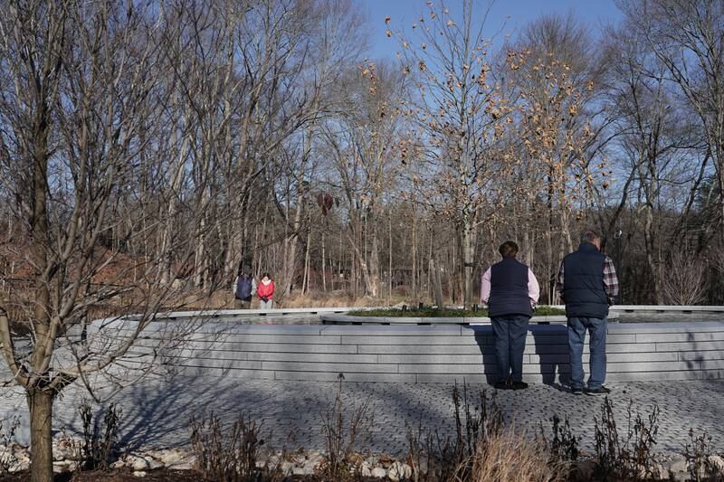 Visitors look at the names of the victims of the Sandy Hook shooting. The National