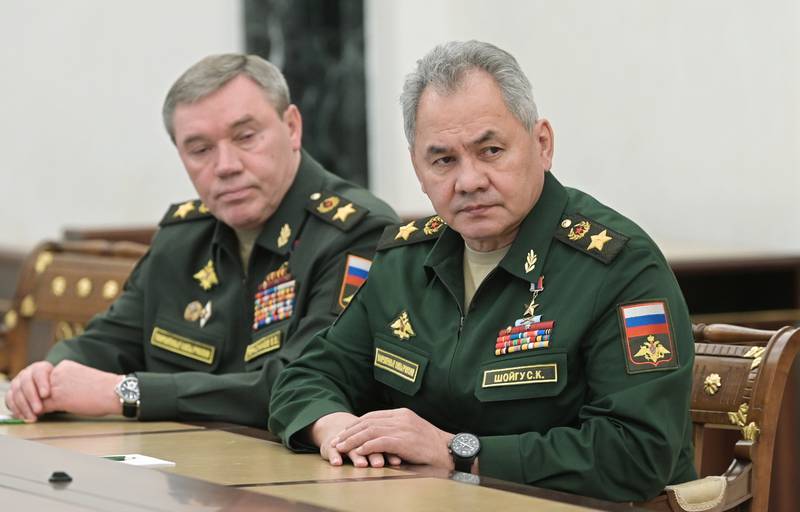 Russian Defence Minister Sergei Shoigu (R) and Chief of the General Staff Valery Gerasimov listen to a speech by President Vladimir Putin in Moscow. AP Photo