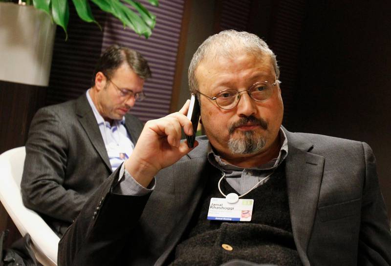 FILE - In this Jan. 29, 2011 file photo, Saudi journalist Jamal Khashoggi speaks on his cellphone at the World Economic Forum in Davos, Switzerland. Eighteen days after Khashoggi disappeared, Saudi Arabia acknowledged early Saturday, Oct. 20, 2018, that the 59-year-old writer has died in what it said was a â€œfistfightâ€ inside the Saudi consulate in Istanbul. (AP Photo/Virginia Mayo, File)