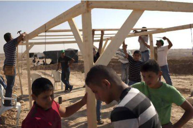 Bedouins build a makeshift house in Al Araqib, a Bedouin village in the Negev Desert as they mark one year since its destruction by Israeli authorities