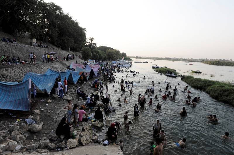 People swim in the Nile as temperatures rise in Cairo.