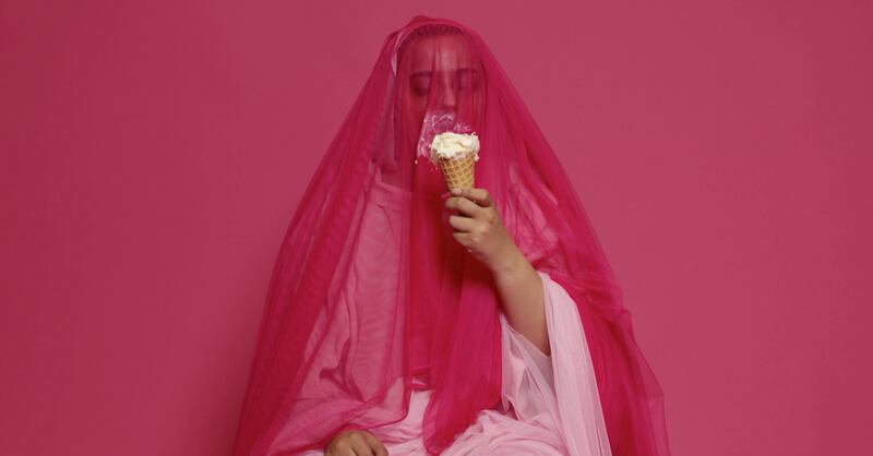 Maitha Hamdan's 'Precautions' is a video work of a person eating ice cream through a veil as a way to satirise sexualised imagery of women