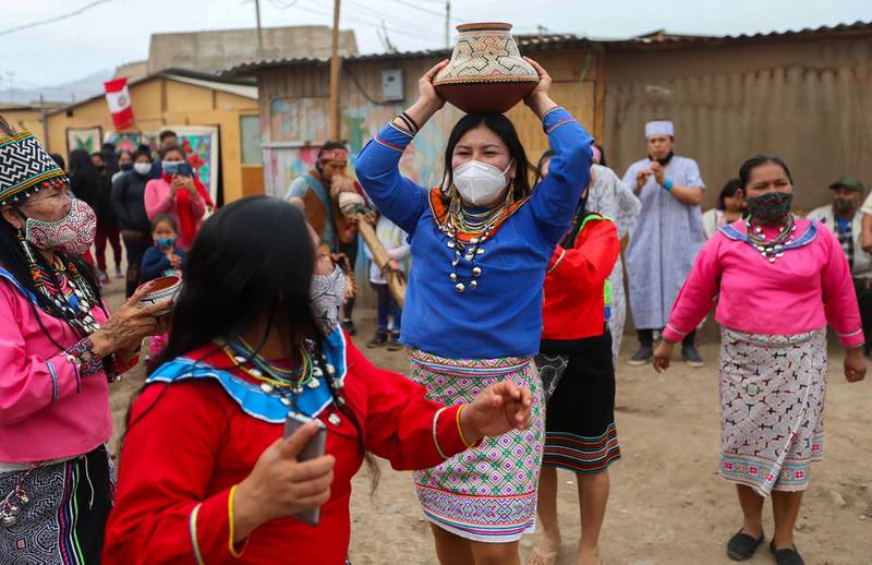 Photo released by Peruvian national news service Andina of a Shipibo-Konibo women wearing protective masks while dancing during the commemoration of the International Day of the World's Indigenous Peoples, at an area where people of this Amazonian ethnic group live, in Lima on August 9, 2020, amid the new coronavirus pandemic.
 RESTRICTED TO EDITORIAL USE - MANDATORY CREDIT AFP PHOTO / ANDINA / JHONEL RODRIGUEZ - NO MARKETING NO ADVERTISIGN CAMPAIGNS -DISTRIBUTED AS A SERVICE TO CLIENTS
 / AFP / ANDINA / JHONEL RODRIGUEZ / RESTRICTED TO EDITORIAL USE - MANDATORY CREDIT AFP PHOTO / ANDINA / JHONEL RODRIGUEZ - NO MARKETING NO ADVERTISIGN CAMPAIGNS -DISTRIBUTED AS A SERVICE TO CLIENTS

