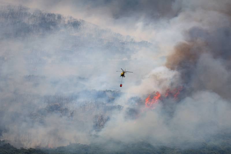 A firefighting helicopter helicopter over a wildfire in Sierra de Leyre, Spain. Reuters