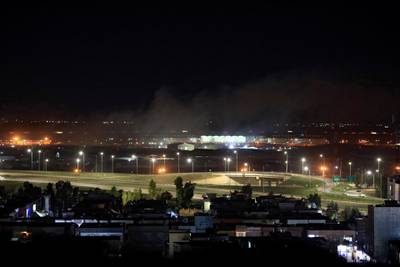 Smoke rises over the Erbil, after reports of mortar shells landing near Erbil airport, Iraq February 15, 2021. REUTERS/Thaier al-Sudani