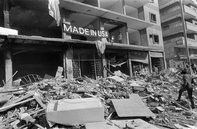 Rescuers search for victims, on March 08, 1985 15 minutes after a car, packed with an estimated 250 kilograms (550 pounds) of TNT exploded in a crowded street of the southern Bir al-Aabed district in mainly Shiite southern suburb of Beirut. At least 75 people were killed and 256 injured in the explosion. The hit area was near the resident of Shiite leader of the Hezbollah Sheikh Mohammed Hussein Fadlallah. A banner was draped over the building whose facade was blown away, reading: "Made in USA". (Photo by NABIL ISMAIL / AFP)