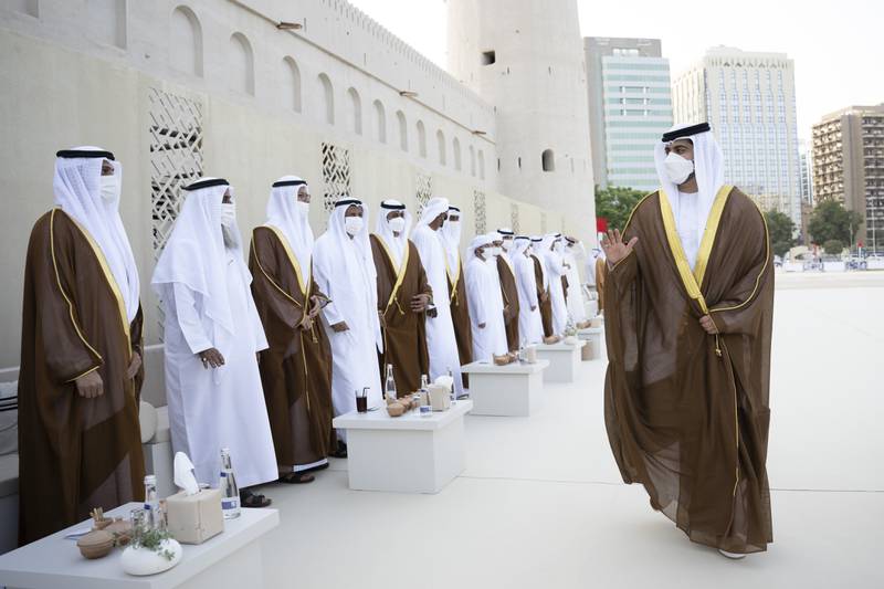 Sheikh Zayed bin Mansour bin Zayed greets grooms during his group wedding with Sheikh Hazza bin Hamdan bin Zayed (not shown) at Qasr Al Hosn. 