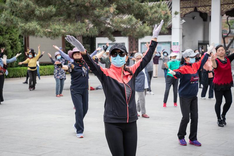 People dance at a park in the Chinese capital Beijing on April 21, 2021. Chinese President Xi Jinping on Tuesday called for greater global economic integration. Bloomberg