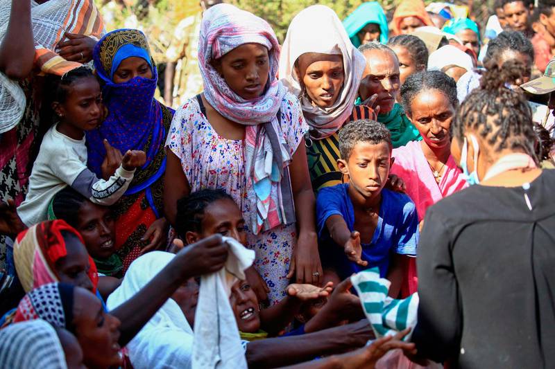 Ethiopian refugees who fled fighting in the Tigray Region receive aid at the Village 8 border reception center in Sudan's eastern Gedaref State. AFP
