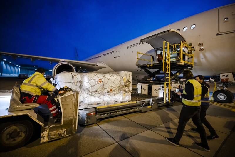 Workers load relief supplies of Swiss Humanitarian Aid for Ukraine population on to an aircraft at Zurich Airport. EPA