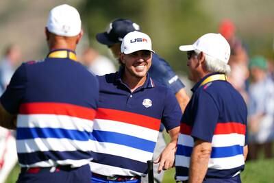 USA's Brooks Koepka, centre,with vice-captain Fred Couples, right. PA