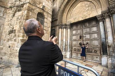 Christian pilgrims used the background for memorable photographs by the  giant closed wooden doors of the Church of the Holy Sepulchre in the Old City of Jerusalem on Monday February 26,2018.The Church of the Holy Sepulchre  remained closed for a second day after church leaders in Jerusalem closed it to protest against Israeli's announced plans by the cityÕs municipality earlier this month to collect property tax (arnona) from church-owned properties on which there are no houses of worship.
(Photo by Heidi Levine for The National).