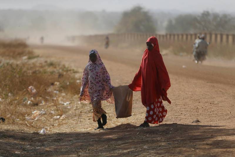 Two women walk past the Government Science Secondary School in Kankara, Nigeria. Rebels from the Boko Haram extremist group claimed responsibility on Tuesday for abducting hundreds of boys from a school in Nigeria's northern Katsina State last week in one of the largest such attacks in years, raising fears of a growing wave of violence in the region. AP Photo