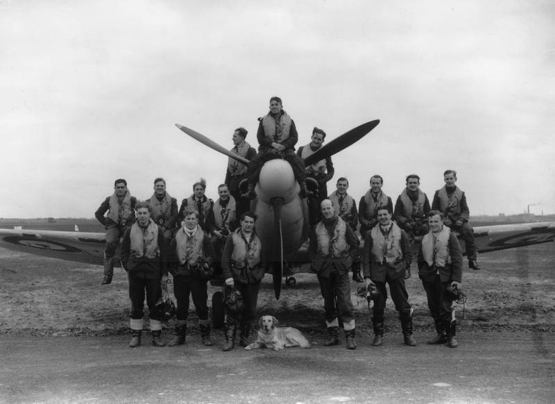 The pilots of a Second World War British fighter squadron crowded around a spitfire with their canine mascot in May 1941. Getty Images