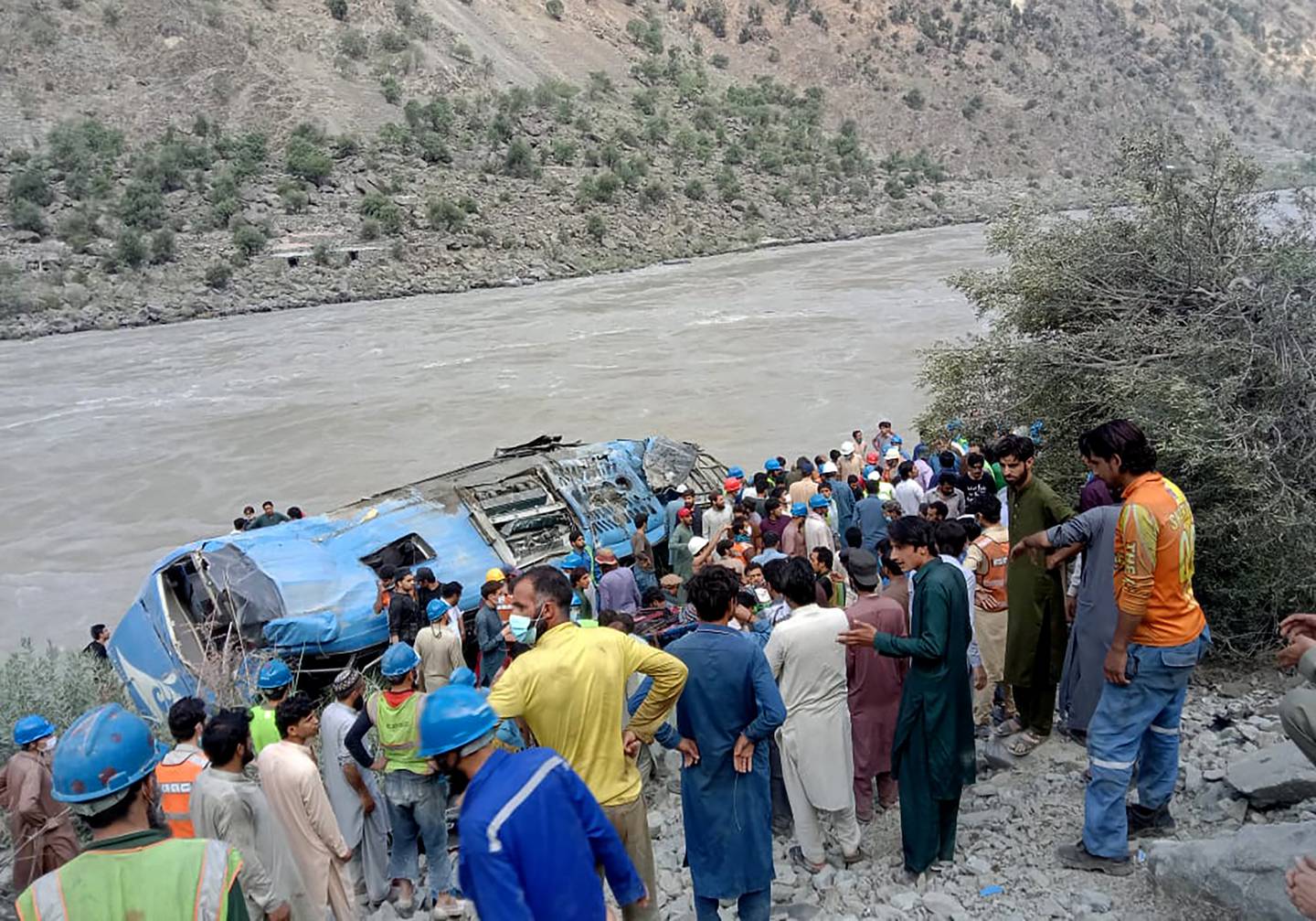Local residents and rescue workers gather at the site of bus accident, in Kohistan Kohistan district of Pakistan's Khyber Pakhtunkhwa province, Wednesday, July 14, 2021. File photo / AP