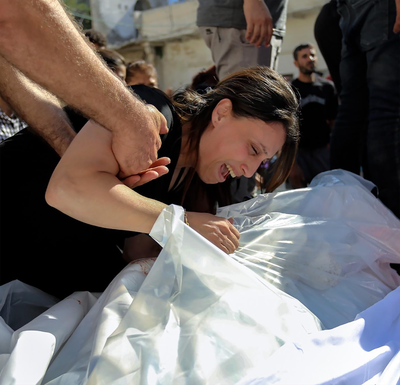 Palestinian Christians mourn family members after an Israeli air strike hit a building in a complex housing one of the oldest churches in the world. Photo: Abed Elhakeem Abo Riash