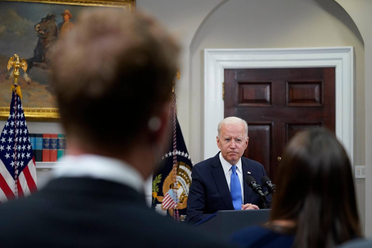 FILE - In this May 13, 2021, file photo President Joe Biden responds to questions from the media after delivering remarks about the Colonial Pipeline hack, in the Roosevelt Room of the White House in Washington. The Centers for Disease Control and Prevention said Thursday that fully vaccinated people â€” those who are two weeks past their last required dose of a COVID-19 vaccine â€” can stop wearing masks outdoors in crowds and in most indoor settings. Across Washington, the government is adjusting in a variety of ways to new federal guidance easing up on when face masks should be worn. (AP Photo/Evan Vucci, File)
