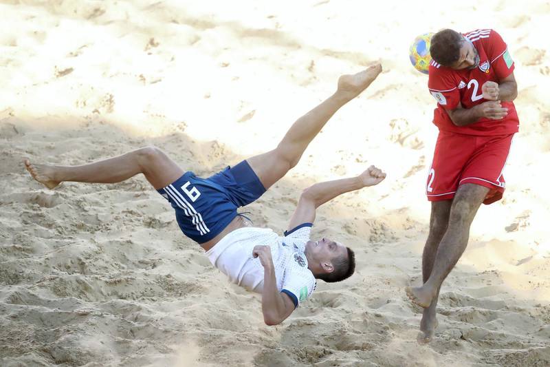 ASUNCION, PARAGUAY - NOVEMBER 24: Boris Nikonorov of Russia is challenged by Haitham Mohamed of United Arab Emirates UAE during the FIFA Beach Soccer World Cup Paraguay 2019 group C match between Russia and United Arab Emirates at Estadio Mundialista "Los Pynandi" on November 24, 2019 in Asuncion, Paraguay. (Photo by Alex Grimm - FIFA/FIFA via Getty Images)