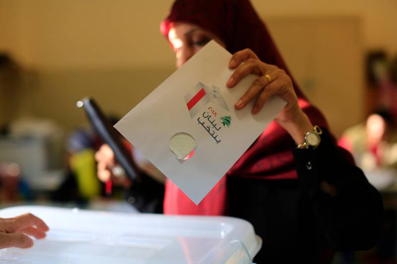 A Lebanese woman casts a ballot at a polling station during the Lebanon's parliamentary elections in a southern suburb of Beirut, Lebanon. Hassan Ammar / AP Photo