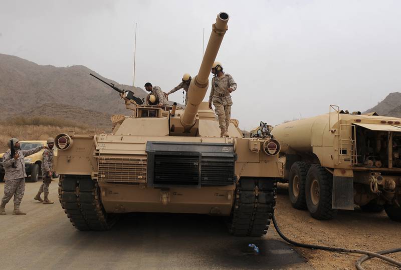 Saudi soldiers are seen on top of their tank deployed at the Saudi-Yemeni border, in Saudi Arabia's southwestern Jizan province. AFP
