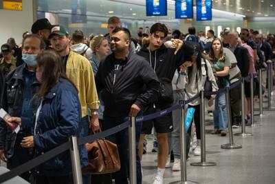One traveller shows his disappointment while waiting in a long queue to pass through a security check in June. Getty Images