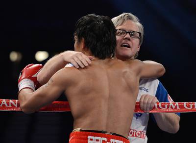 LAS VEGAS, NV - JUNE 09:  (R-L) Trainer Freddie Roach gives Manny Pacquiao a hug between rounds during his bout against Timothy Bradley at MGM Grand Garden Arena on June 9, 2012 in Las Vegas, Nevada.  (Photo by Kevork Djansezian/Getty Images)