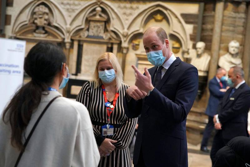 Prince William speaks to staff during a visit to the vaccination center at Westminster Abbey. AP Photo