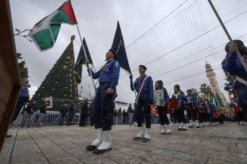 Palestinian scouts march during a ceremony at Bethlehem's Church of the Nativity. AFP