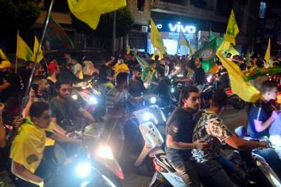 Lebanese youths supporting Hezbollah and Amal movement wave their party flags after parliamentary elections in a suburb of Beirut. EPA