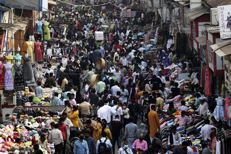 FILE - Indians wearing face masks as a precaution against the COVID-19, crowd a market, in Mumbai, India, on Jan.  7, 2022.  The United Nations estimated Monday, july 11, 2022 that the world’s population will reach 8 billion on Nov.  15 and that India will replace China as the world’s most populous nation next year.  (AP Photo / Rajanish Kakade, File)