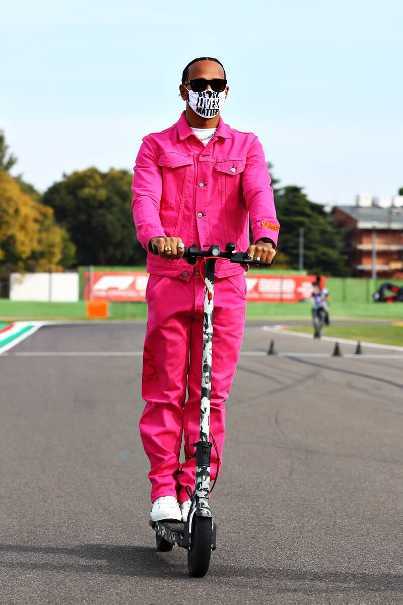 Lewis Hamilton, in a pink denim co-ordinated set by  Heron Preston x Levis 501, rides a scooter ahead of the F1 Grand Prix in Imola, Italy, on October 30, 2020. Getty Images