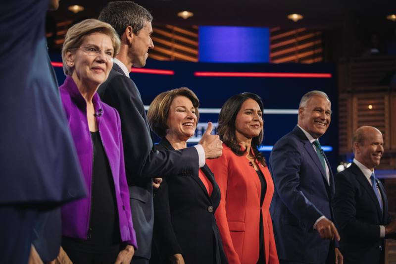 2020 Democratic presidential candidates Senator Elizabeth Warren, a Democrat from Massachusetts, from left, Beto O'Rourke, former Representative from Texas, Senator Amy Klobuchar, a Democrat from Minnesota, Representative Tulsi Gabbard, a Democrat from Hawaii, Jay Inslee, governor of Washington, and Former Representative John Delaney stand on stage during the Democratic presidential candidate debate in Miami, Florida, U.S., on Wednesday, June 26, 2019. Democratic presidential candidates tangled on health care in their first debate Wednesday, agreeing on the need for universal coverage but disagreeing about whether private insurance should be maintained. Photographer: Jayme Gershen/Bloomberg
