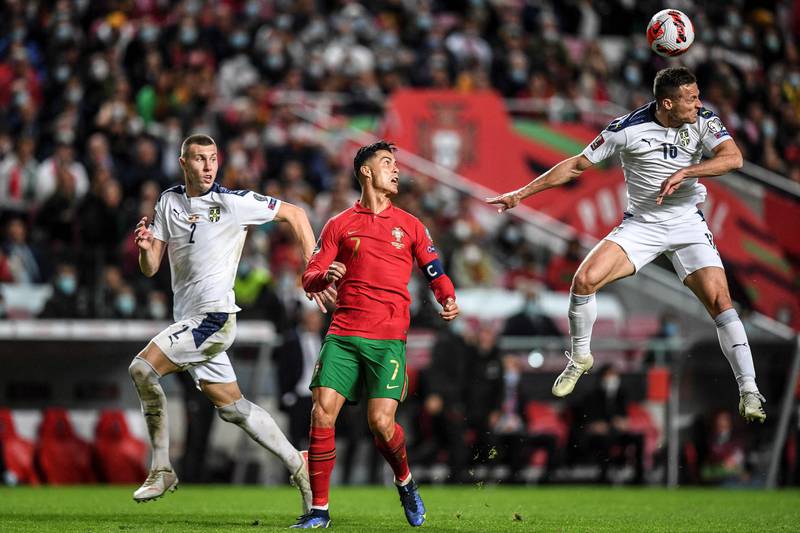 Serbia defender Uros Spajic heads the ball next to Portugal's forward Cristiano Ronaldo. AFP