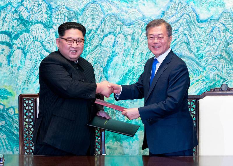 FILE - In this April 27, 2018 file photo, North Korean leader Kim Jong Un, left, and South Korean President Moon Jae-in shake hands after signing on a joint statement at the border village of Panmunjom in the Demilitarized Zone, South Korea. Seoul says North Korean leader Kim plans to shut down the country's nuclear test site in May and reveal the process to experts and journalists from the United States and South Korea. Seoul's presidential spokesman Yoon Young-chan said Sunday, April 29,  Kim made the comments during his summit with South Korean President Moon Jae-in on Friday.(Korea Summit Press Pool via AP)