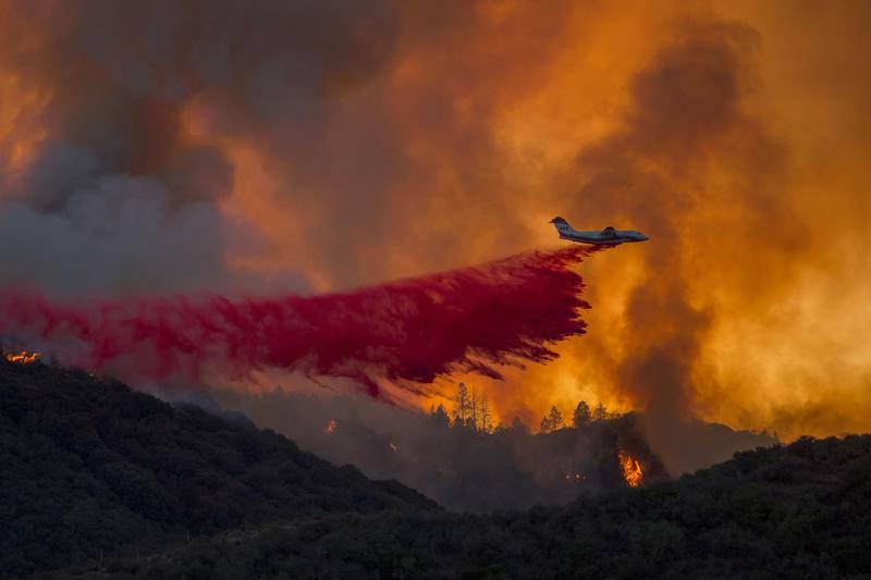 A firefighting airplane drops fire retardant at the Holy Fire near Lake Elsinore, in Orange County, California. AFP Photo