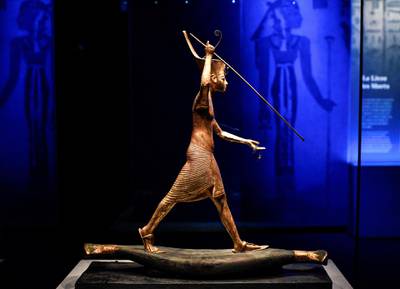A statuette of Tutankhamun is displayed during the exhibition 'Tutankhamun,Treasures of the Golden Pharaoh' on March 21, 2019 at La Villette in Paris. - The exhibition dedicated to the famous Pharaoh Tutankhamun, with 150 original objects collected from his tomb, takes place in the Grande Halle de La Villette in Paris from March 23 to September 15, 2019. (Photo by STEPHANE DE SAKUTIN / AFP) / RESTRICTED TO EDITORIAL USE - TO ILLUSTRATE THE EVENT AS SPECIFIED IN THE CAPTION