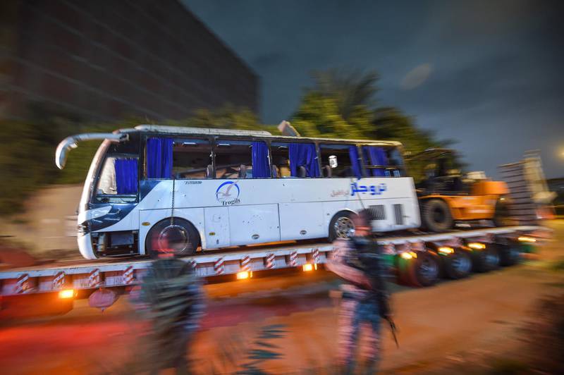 The bus is towed away from the scene. Three Vietnamese holidaymakers and an Egyptian tour guide were killed. AFP