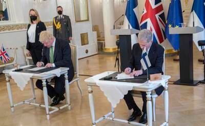 The leaders sign the security declaration between Finland and the UK. EPA
