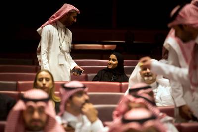 Vsitors wait for the movie to begin during an invitation-only screening, at the King Abdullah Financial District Theater, in Riyadh, Saudi Arabia, Wednesday, April 18, 2018. Saudi Arabia hold a private screening of the Hollywood blockbuster "Black Panther" Wednesday, to herald the launch of movie theaters that are set to open to the public next month. (AP Photo/Amr Nabil)