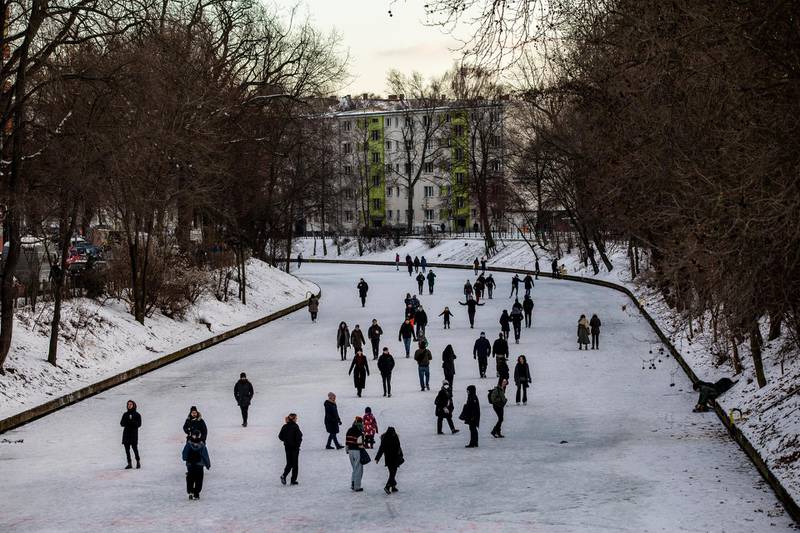 People gather to walk on the frozen Landwehr Canal in Berlin, Germany. Getty