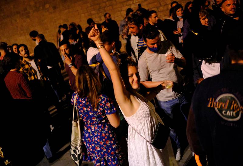 People in Barcelona celebrate the expiry of a six-month coronavirus curfew in Spain on Saturday. Reuters