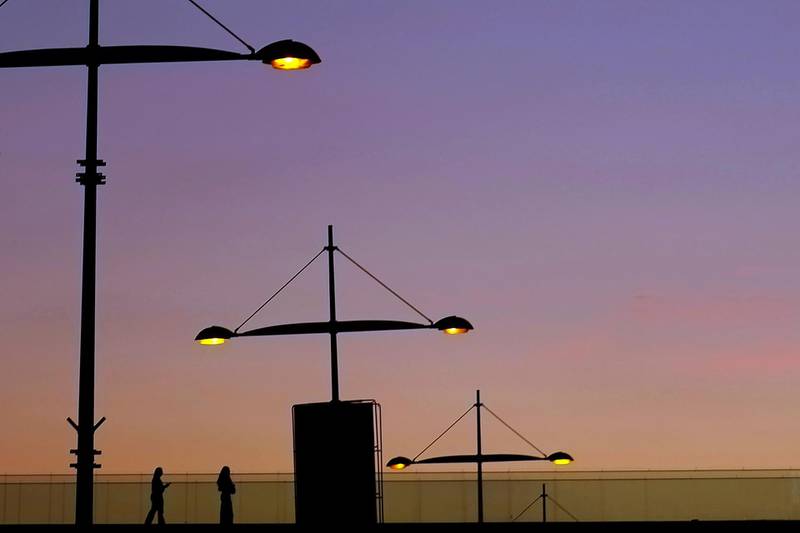 Women walk near a bridge during sunset in the southern coastal city of Limassol, Cyprus. AP Photo