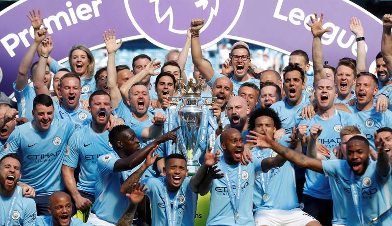 Manchester City players celebrate with the Premier League trophy. Carl Recine / Reuters