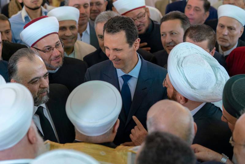 Syria's President Bashar Al-Assad greets his supporters during Eid al-Adha prayers at a mosque in Damascus, Syria in this handout picture provided by Syrian Arab News Agency on August 21, 2018. SANA/Handout via REUTERS ATTENTION EDITORS - THIS IMAGE WAS PROVIDED BY A THIRD PARTY. REUTERS IS UNABLE TO INDEPENDENTLY VERIFY THIS IMAGE.      TPX IMAGES OF THE DAY