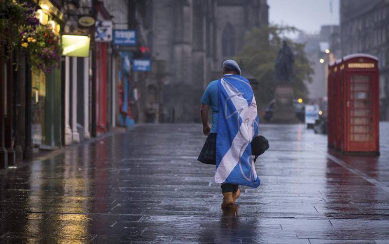 A lone "yes" campaign supporter walks down a street in Edinburgh after the result of the Scottish independence referendum, Scotland, on Friday. Stefan Rousseau / AP Photo