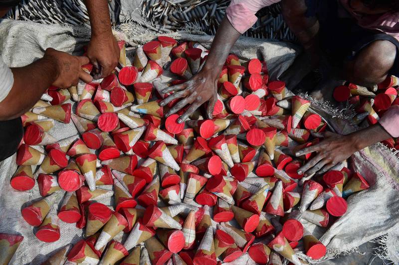 Workers lay out firecrackers for drying at a workshop on the outskirts of Ahmedabad. AFP