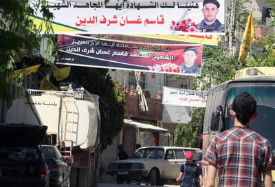 Banners celebrating a Lebanese fighter, who died fighting alongside Syrian government forces battling rebels, hang above a street Baalbek. The Lebanese government has started a campaign to remove such posters in a bid to reduce tensions. AFP PHOTO