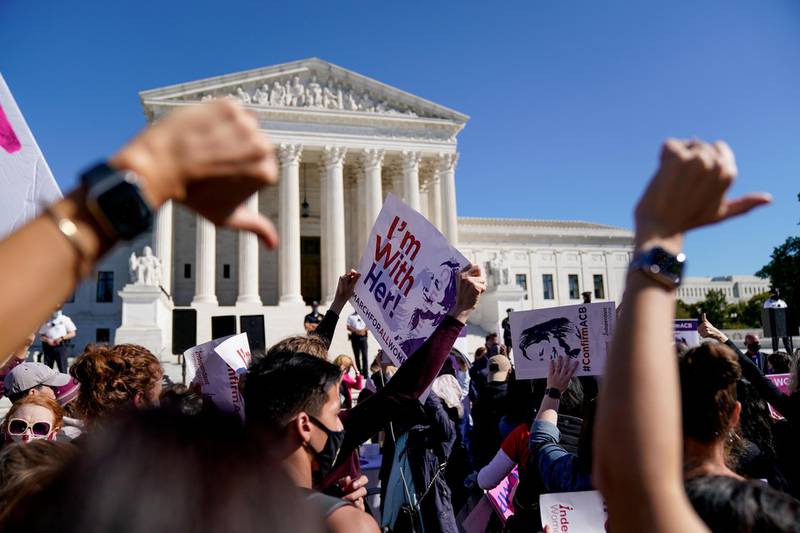 Protesters gesture to supporters of Judge Amy Coney Barrett outside the U.S. Supreme Court during a nationwide protest against U.S. President Donald Trump's decision to fill the seat on the Supreme Court left by the passing of late Justice Ruth Bader Ginsburg before the 2020 election, in Washington, U.S., October 17, 2020. REUTERS/Erin Scott